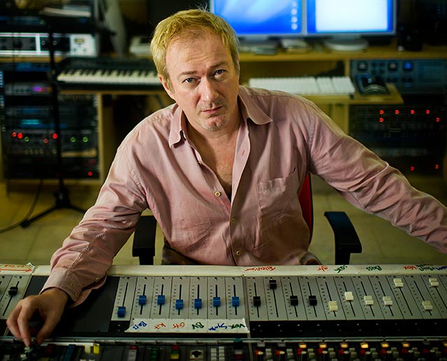 Music producer Andy Gill at the mixing desk in his recording studio
